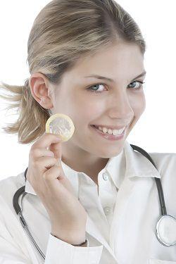 Female Doctor holding condoms